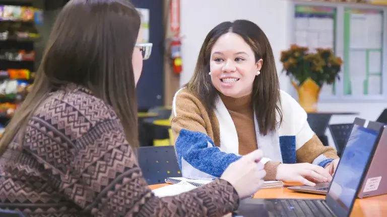 Two Women in Front of Laptops